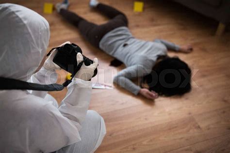 Murder Investigation And Forensic Examination Concept Criminalist With Camera Photographing