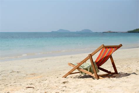 Chaise Lounge On The Tropical Beach At Sunny Summer Day Stock Photo