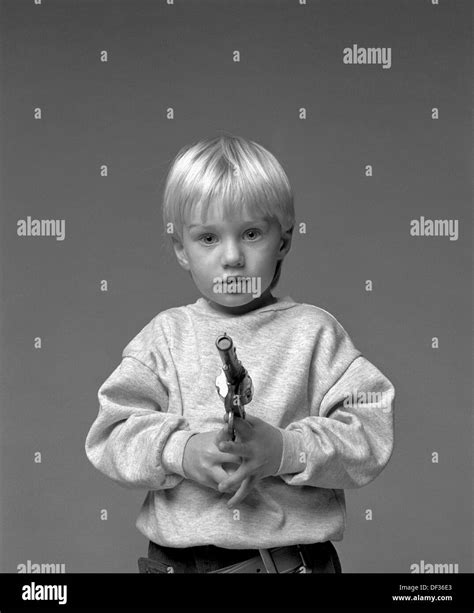 Young Boy Holding Toy Gun Stock Photo Alamy