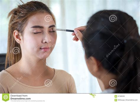Asian Woman Applying Mascara On Her Long Eyelashes Stock Image Image