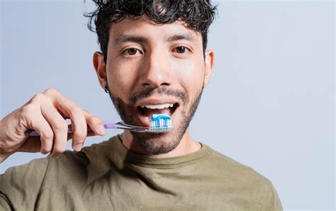 Premium Photo Close Up Of Man Brushing His Teeth Isolated Face Of