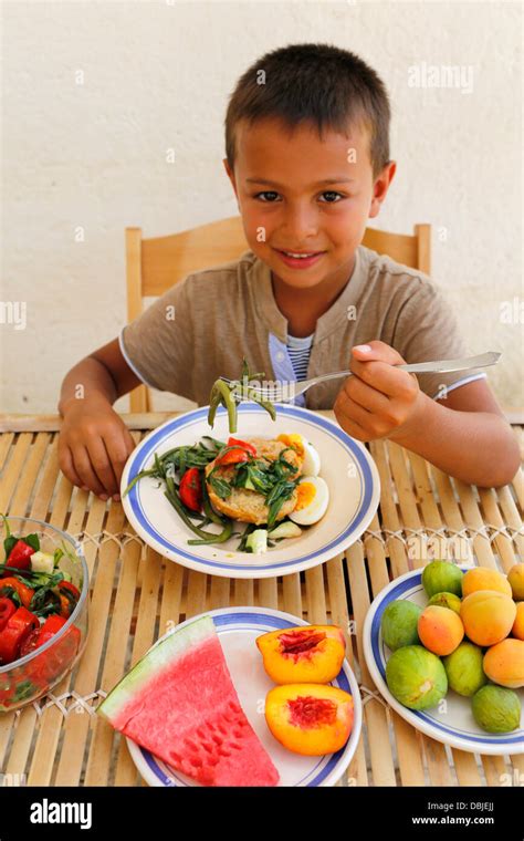 6 Year Old Boy Eating Fruit And Vegetables Stock Photo Alamy