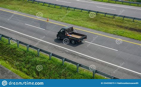 Black Daihatsu Gran Max Pickup Truck On Trans Jawa Highway Stock Image