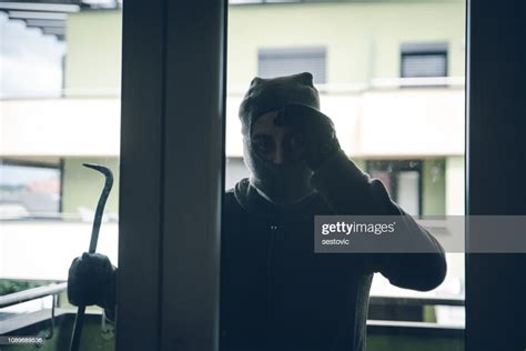 Burglar Breaking Into House High Res Stock Photo Getty Images