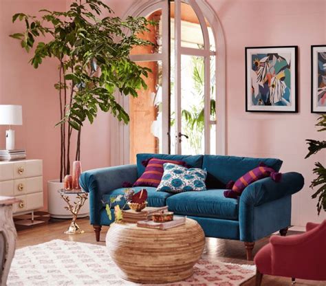 Light Pink Living Room Features A Vibrant Blue Wing Sofa Paired With A