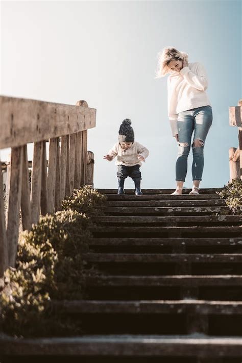 A Mother And Her Child Going Down The Stairs · Free Stock Photo