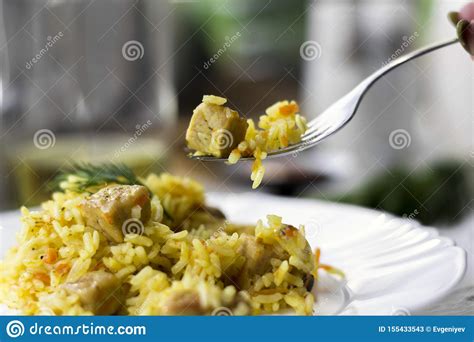 Traditional Pilaf Rice With Meat Carrots And Onions On A White