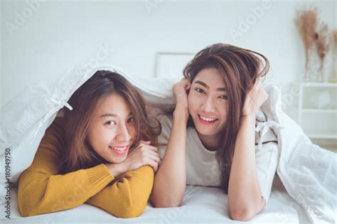 Lgbt Lovely Lesbian Couple Together Concept Couple Of Young Women Lying And Using Smart Phone