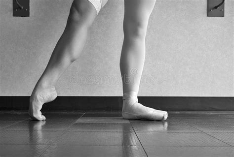black and white version of the hardworking disciplined ballerina ballet dancer warming up in her