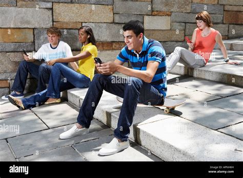Teenagers Using Mobile Phones Stock Photo Alamy