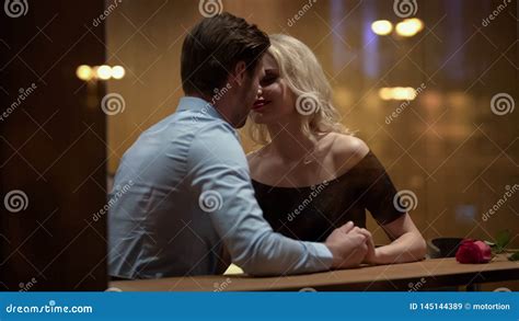 Loving Couple Kissing In Restaurant Enjoying Each Other Romantic Date Passion Stock Image