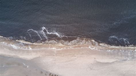 Drone Aerial View Of The Waves Washing On The Redondo Sand Beach High