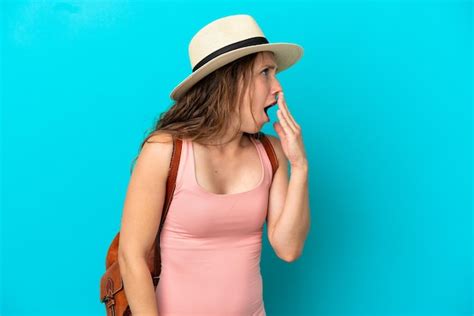 Premium Photo Young Caucasian Woman In Summer Holidays Isolated On Blue Background Yawning And
