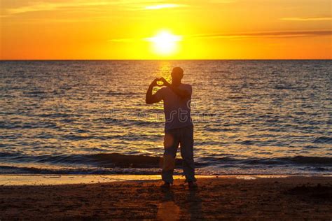 A Man Enjoys Life On The Beach At Sunset Stock Image Image Of Evening