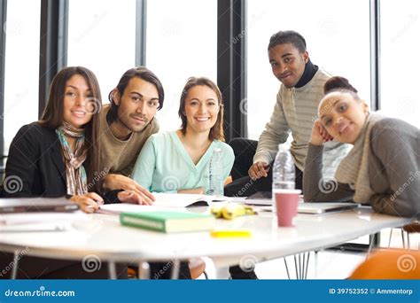 Happy Young Students At Table Studying Together Stock Photo Image Of