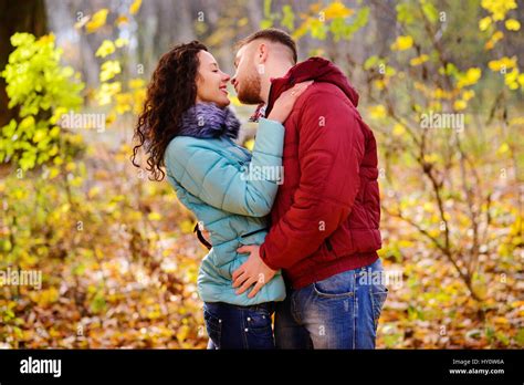 Portrait Of Young Loving Couple Kissing In Autumn Park Stock Photo Alamy
