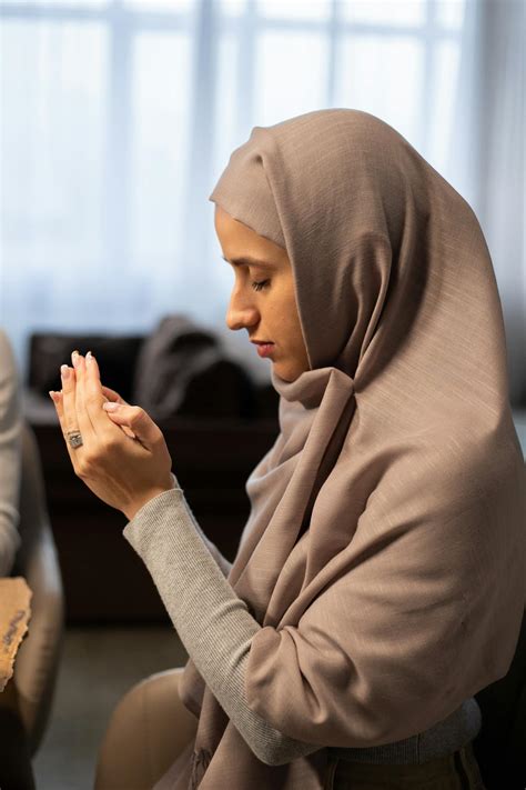 Muslim Woman With Closed Eyes Praying At Table · Free Stock Photo