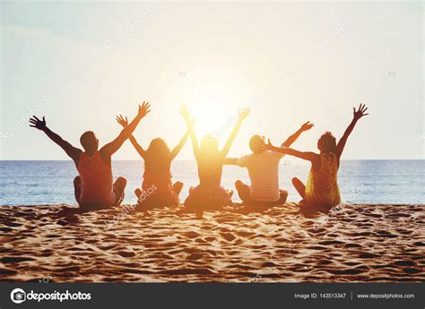 Group Happy People Beach Sea Sunset Concept Stock Photo By ©cppzone