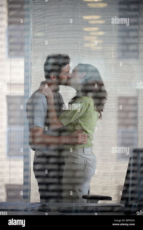 Couple Kissing In Office Stock Photo Alamy