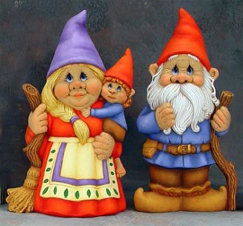 A Group Of Gnome Figurines Standing Next To Each Other In Front Of A
