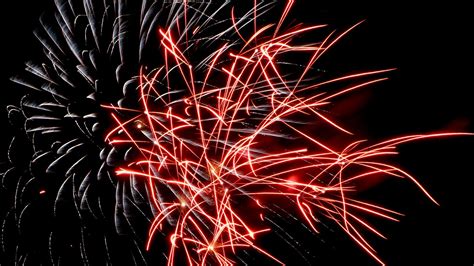 Download Wallpaper 1366x768 Fireworks Sparks Glow Red White Tablet