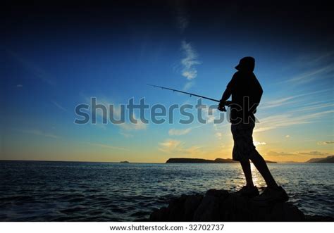 Man Fishing On Sunset Stock Photo Edit Now 32702737