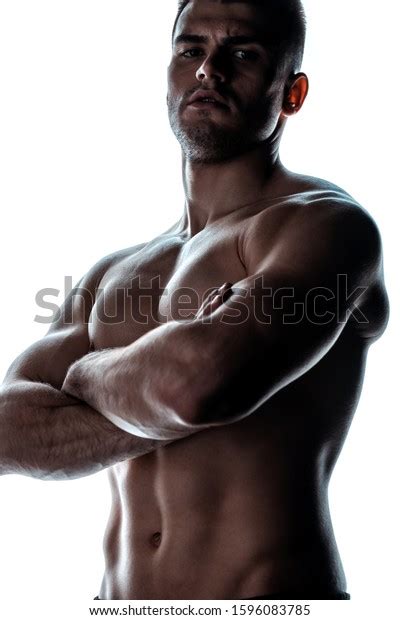 Sexy Muscular Bodybuilder With Bare Torso Posing With Crossed Arms In
