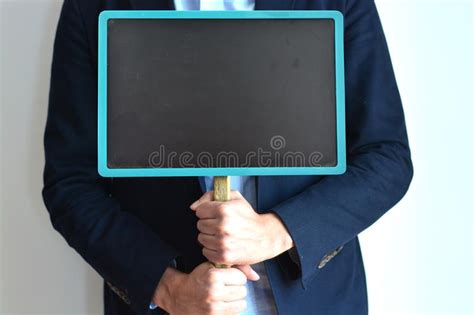 Businessman Holding Blank Placard Or Blackboard With Copy Space Stock
