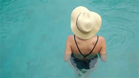 Sexy Woman In Hat Chilling In The Swimming Pool By Stocksy Contributor Nikita Sursin Stocksy