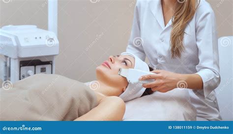 The Doctor Cosmetologist Makes The Ultrasound Cleaning Procedure Of The