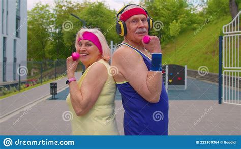 Active Elderly Old Sports Team Grandmother Grandfather Weightlifting Dumbbells Smiling At