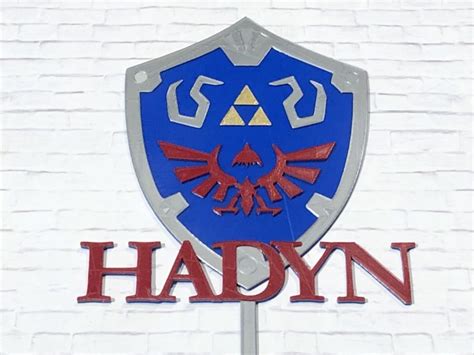 In the game, you will often lack funds you can spend on so many things. Zelda Hylian Shield Personalized Birthday Cake Topper - 3D Wade Creations