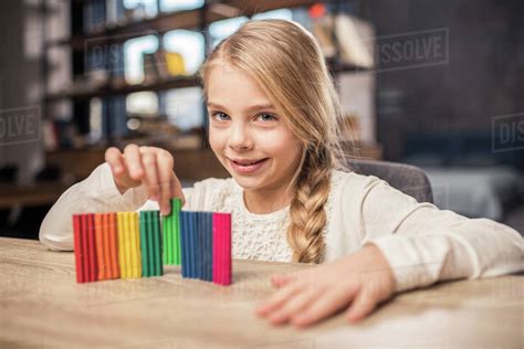 Cute Preteen Girl Playing With Colorful Plasticine And Smiling At