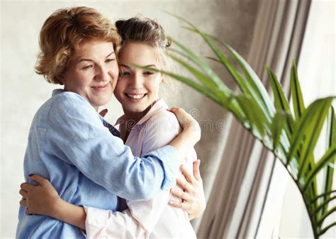 Happy Senior Mother Embracing Adult Daughter Laughing Together Smiling Excited Aged Older Lady