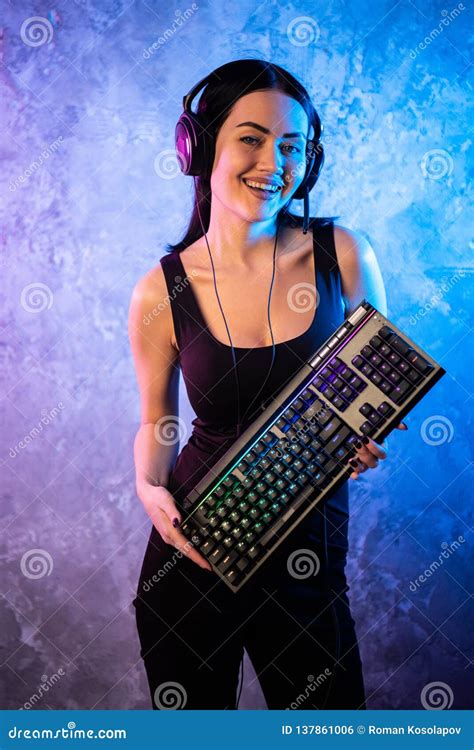 Beautiful Friendly Pro Gamer Streamer Girl Posing With A Keyboard In Her Hands Wearing Glasses
