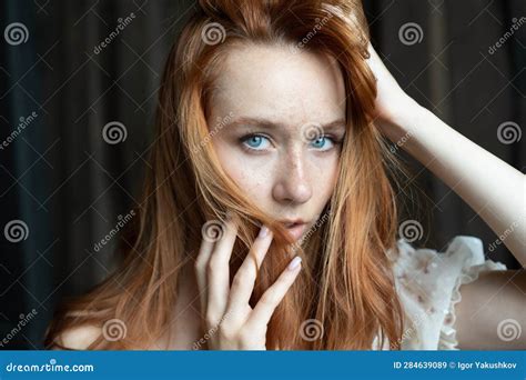 Portrait Of A Young Beautiful Woman With Red Hair Holding Her Hands Near Her Face Stock Image