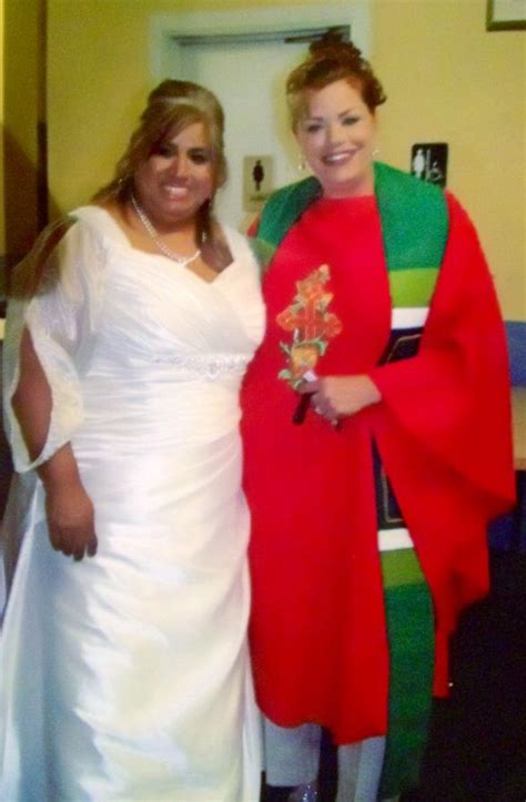 two women dressed in costumes standing next to each other at a wedding ceremony one woman