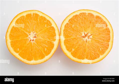 Orange Fruit Cut In Half Showing Both Halves Stock Photo Alamy