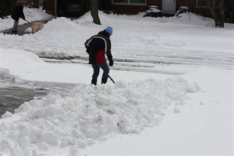 31362919 Lady Shoveling The Deep Snow Off Her Driveway After A Snow