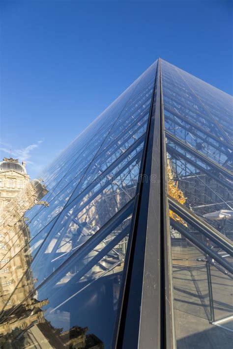 Reflection Of The Louvre Building In The Glass Pyramid Of The Louvre