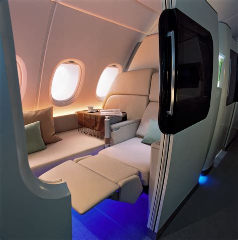 The Inside Of An Airplane With Couches And Windows