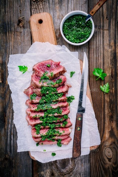 Fried chicken has been described as being crunchy and juicy, as well as crispy. Sliced grilled barbecue beef steak with green chimichurri sauce Stock Photo by nblxer