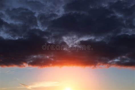 Epic Dramatic Sunset Sunrise On Storm Sky With Dark Clouds Orange