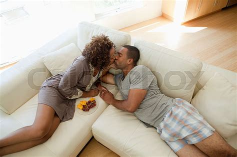 Young Couple Kissing On Sofa High Angle View Stock Image Colourbox
