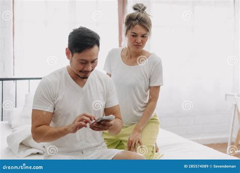 Funny Couple Wife Peeking Husband Who Chatting On The Smartphone