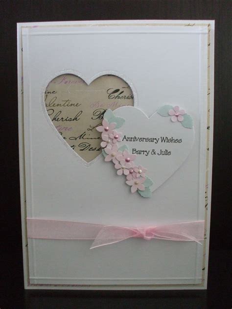 A Heart Shaped Card With Pink Ribbon On It