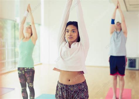 Woman With Arms Overhead In Yoga Class Stock Image F0155545