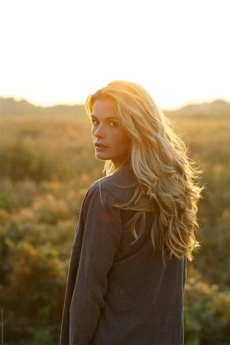 Young Woman With Blonde Hair In Nature At Sunset By Stocksy