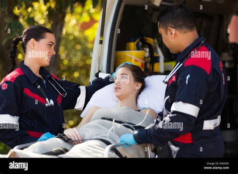 Paramedic Team Talking To Young Patient Before She Going Into An