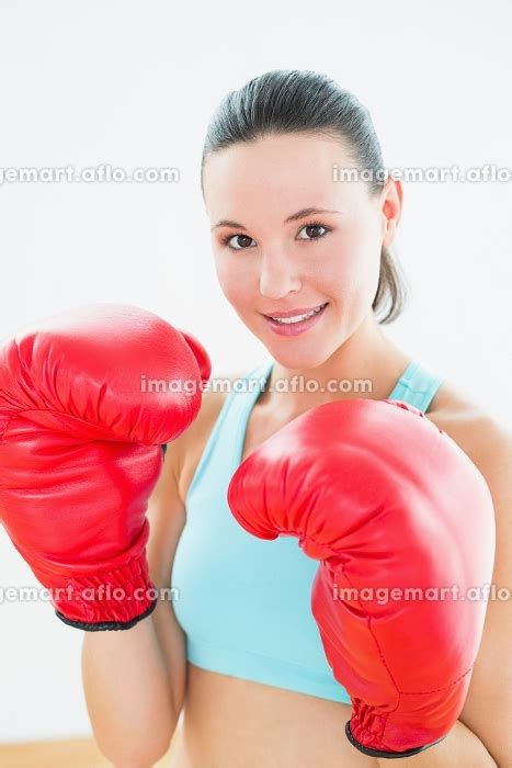 Close Up Portrait Of A Beautiful Young Woman In Red Boxing Gloves At